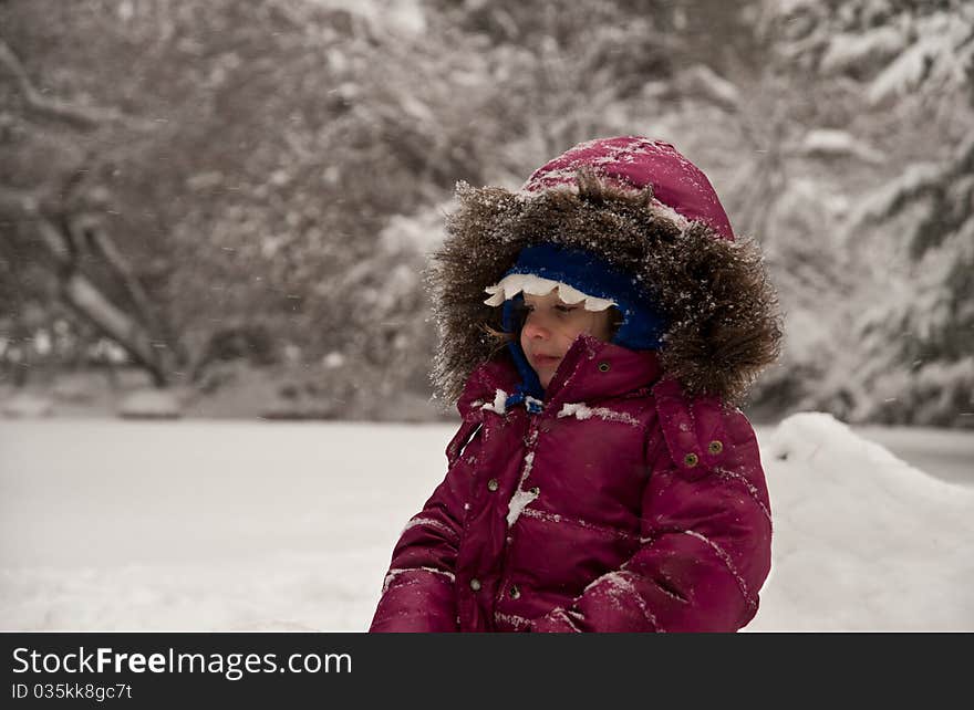 Little Girl Sitting In The Snow. Little Girl Sitting In The Snow