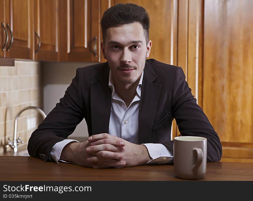 Man Sitting At The Kitchen Counter