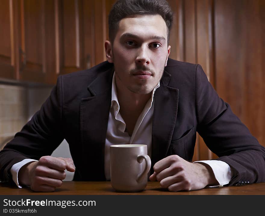 Man Sitting At The Kitchen Counter