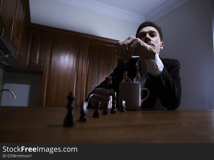 Thoughtful man throwing chess in the cup.