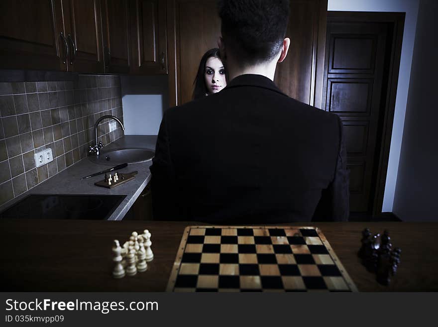 Men sitting back against a chessboard. Photo.