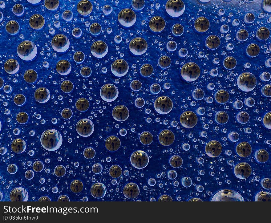 Water droplets on a blue background macro shot. Water droplets on a blue background macro shot