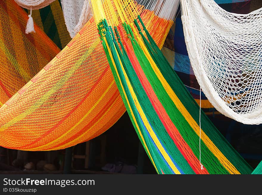 Details of colorful hammocks in a Mexican market.