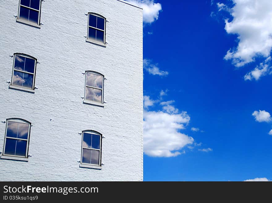 Cloudy Windows on white building