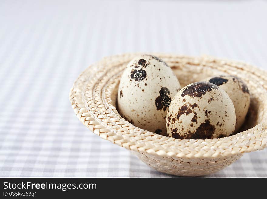 Quail eggs in a decorative wicker hat