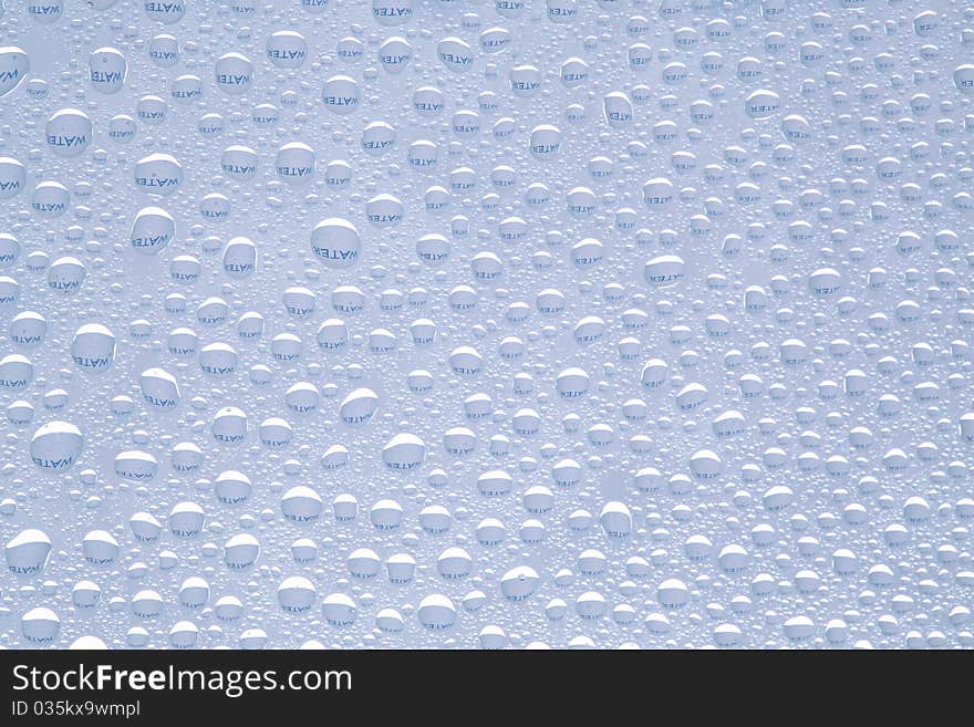 Water text refracted in drops of water ideal as a background. Water text refracted in drops of water ideal as a background.