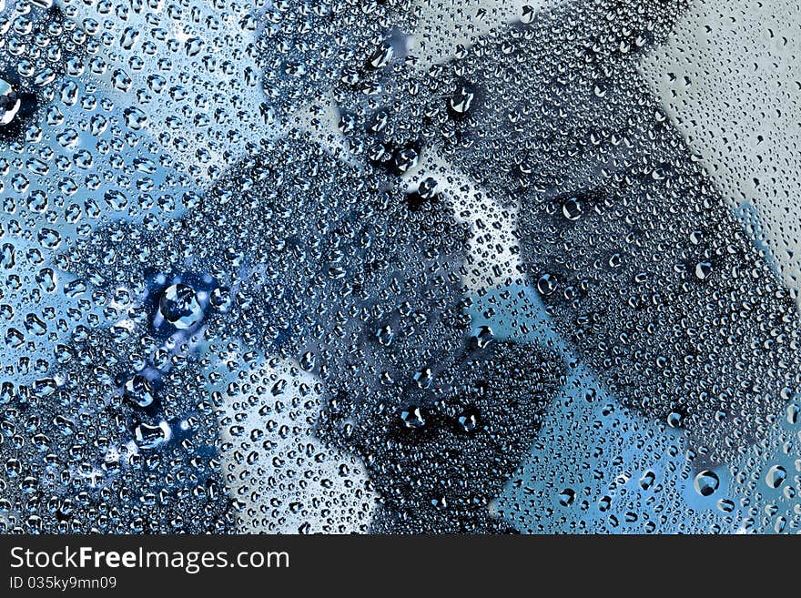 Pattern refracted in drops of water ideal as a background. Pattern refracted in drops of water ideal as a background.