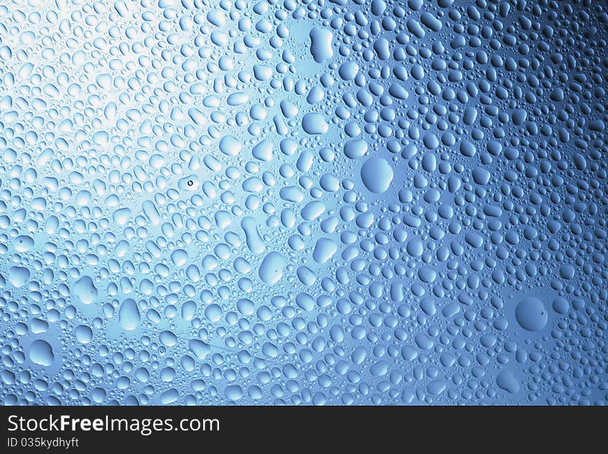 Pattern refracted in drops of water ideal as a background. Pattern refracted in drops of water ideal as a background.