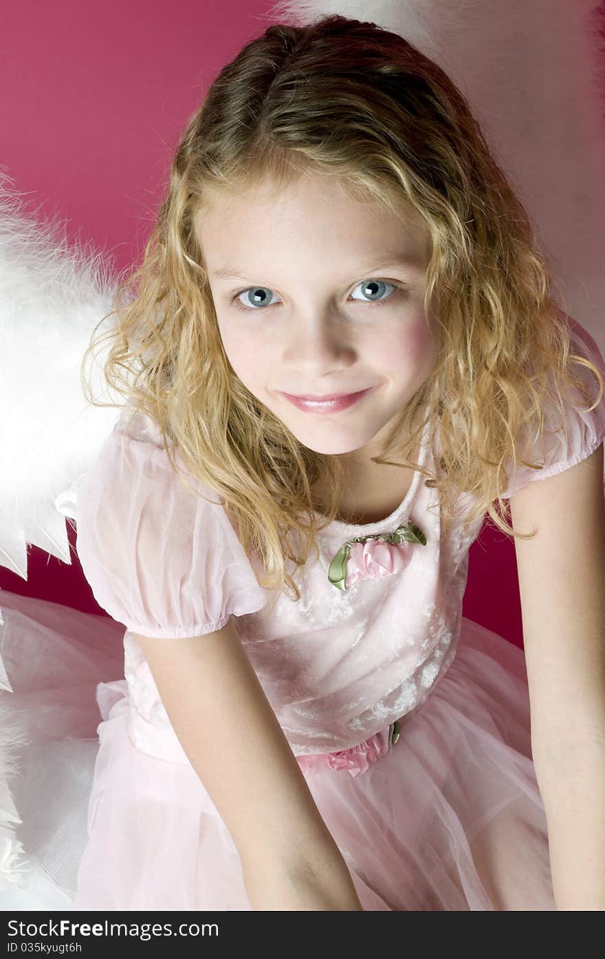 Beautiful little angel girl with wings and pink dress