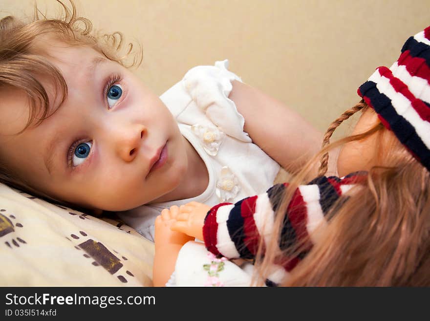 Little blue eyes curly girl with doll. Little blue eyes curly girl with doll