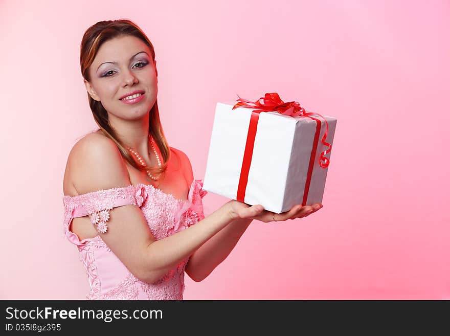 Happy girl with gift box over white