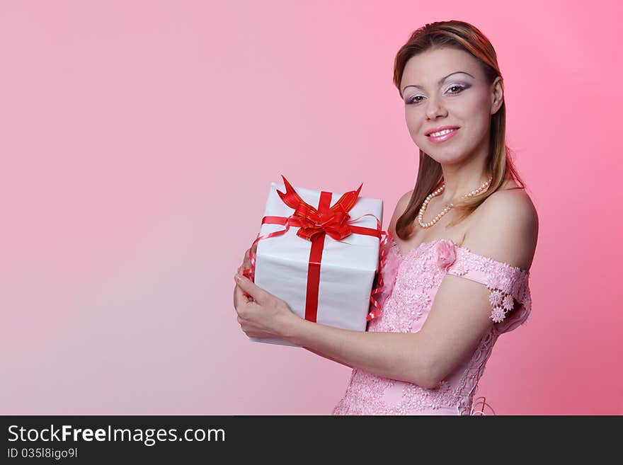 Happy girl with gift box over white