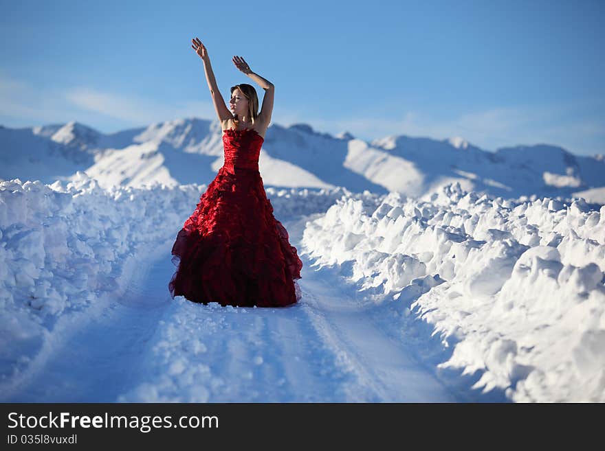 The girl on snow road to mountains