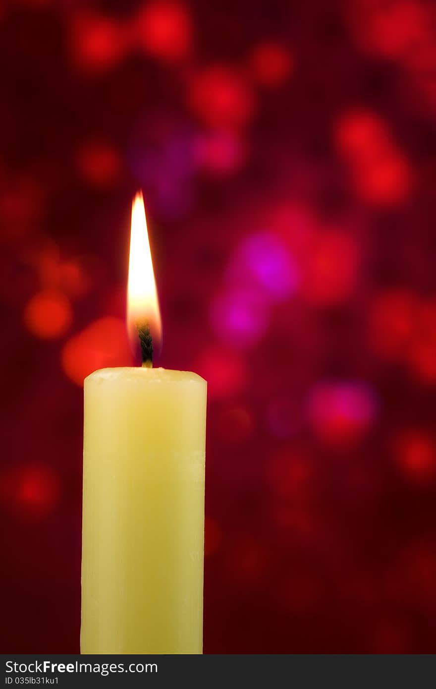 Single lit candle on red abstract back ground. Single lit candle on red abstract back ground