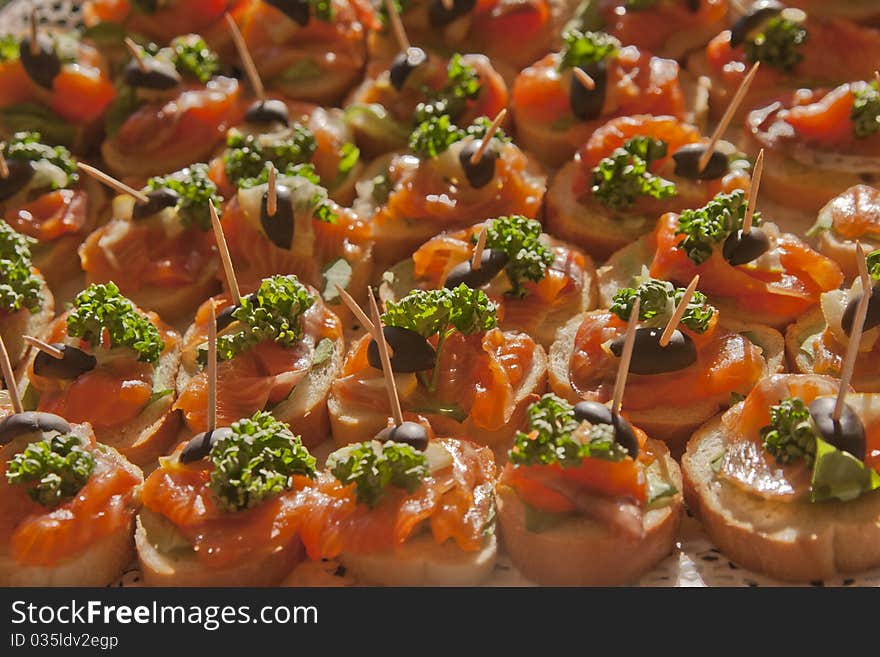 Mini-sandwiches with a red fish of cold smoking an