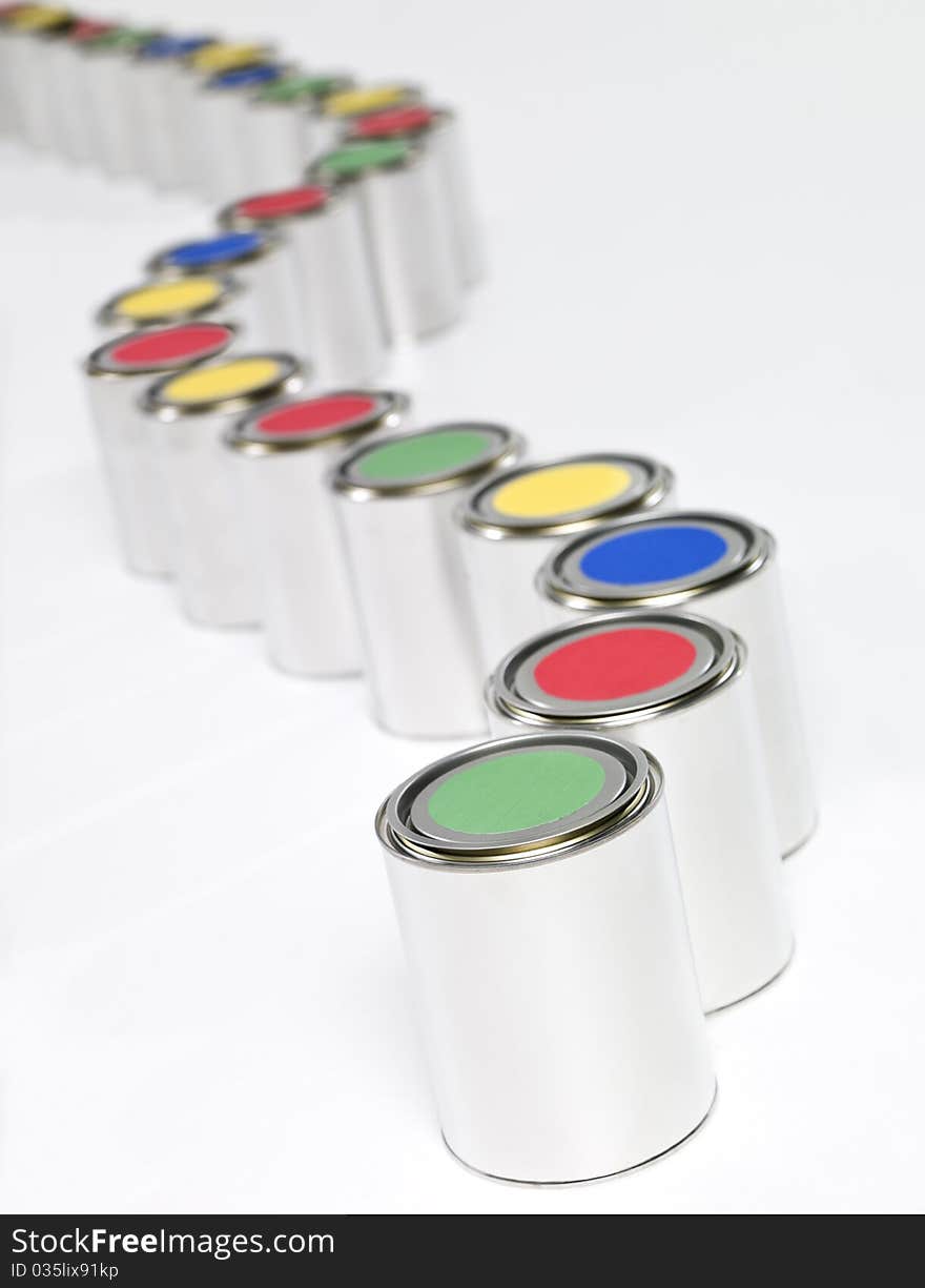 Colored Paint cans in a row on white background