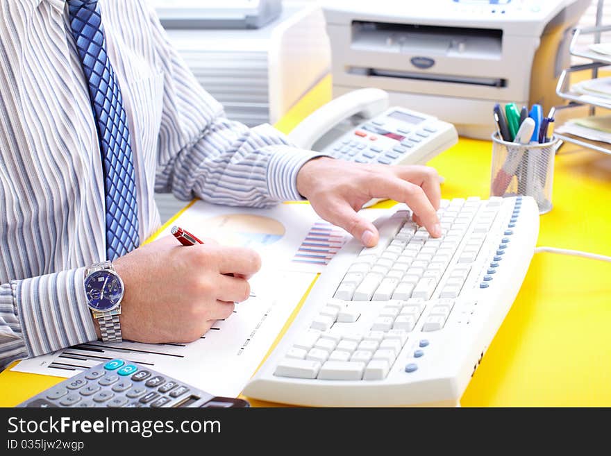 Male hands typing on a white keyboard