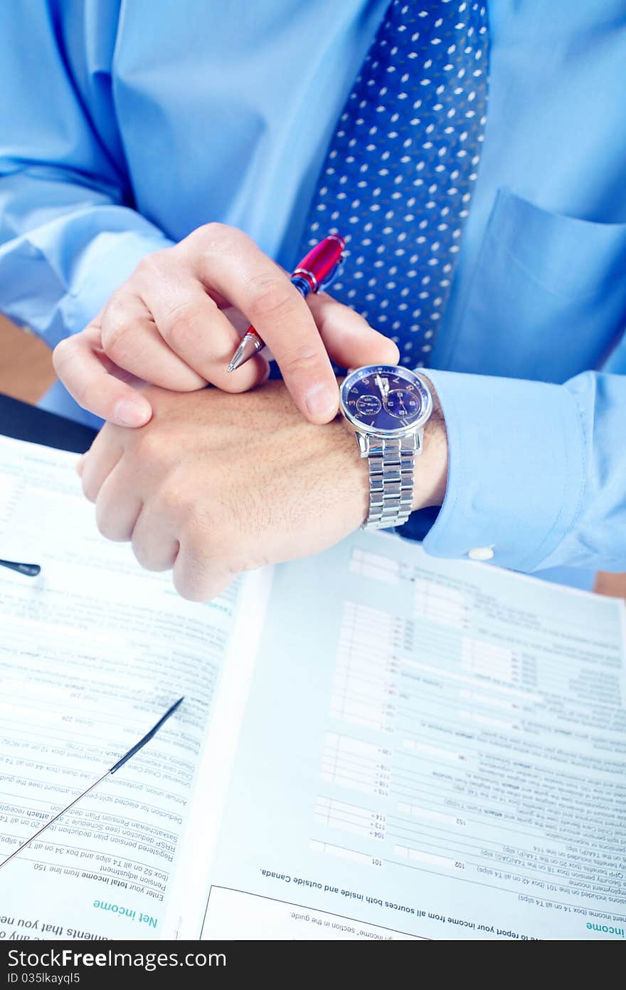 Businessman looking at the watch. Businessman looking at the watch