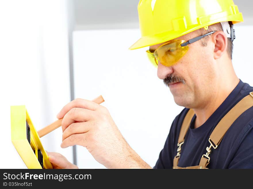 Mature contractor working. Over white background