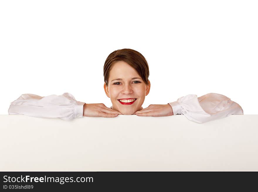 Young happy woman leans on blank billboard