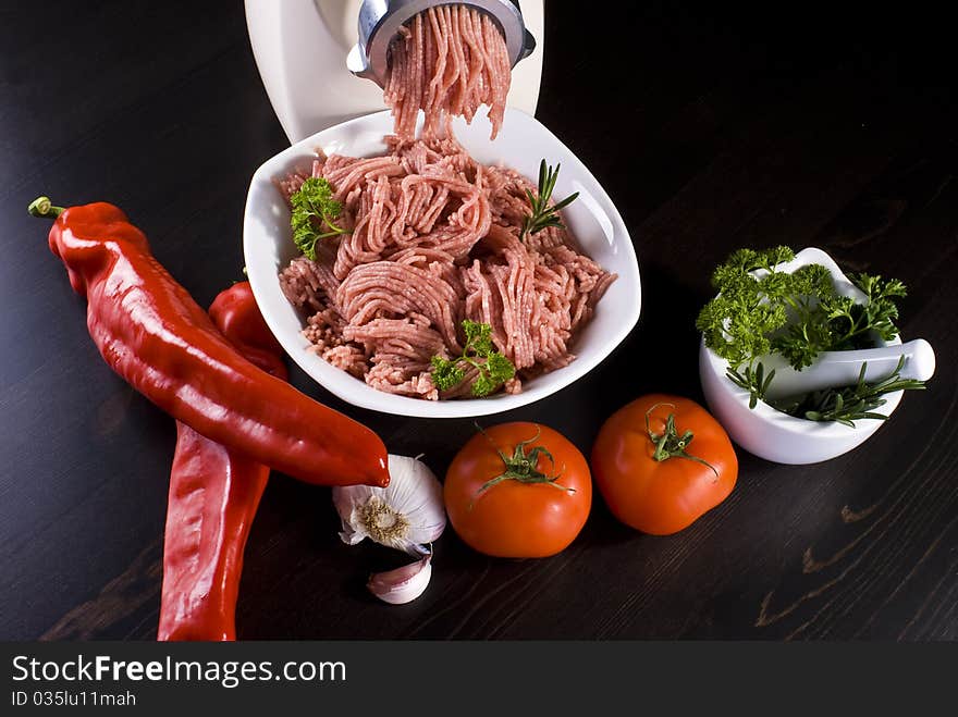 Bowl of mince with electric meat grinder and vegetables. Bowl of mince with electric meat grinder and vegetables