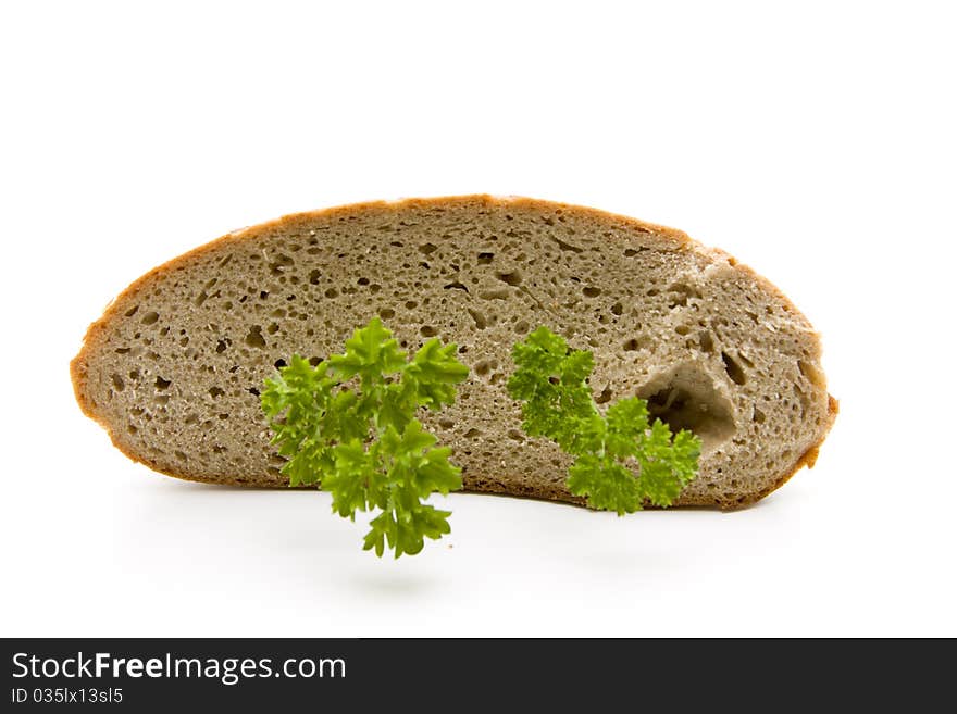 Fresh bread cut with parsley onto white background. Fresh bread cut with parsley onto white background