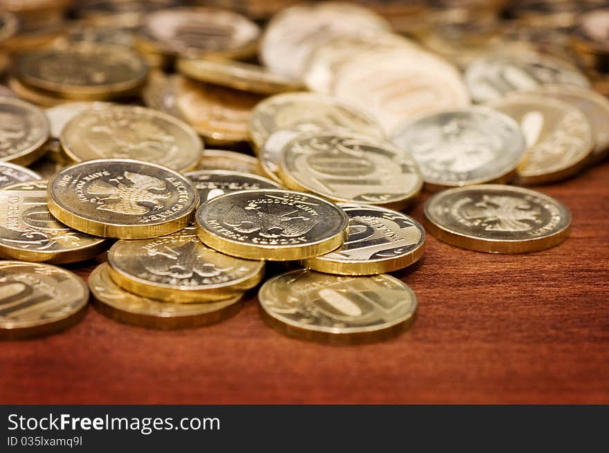 Golden Coins On A Wooden Table