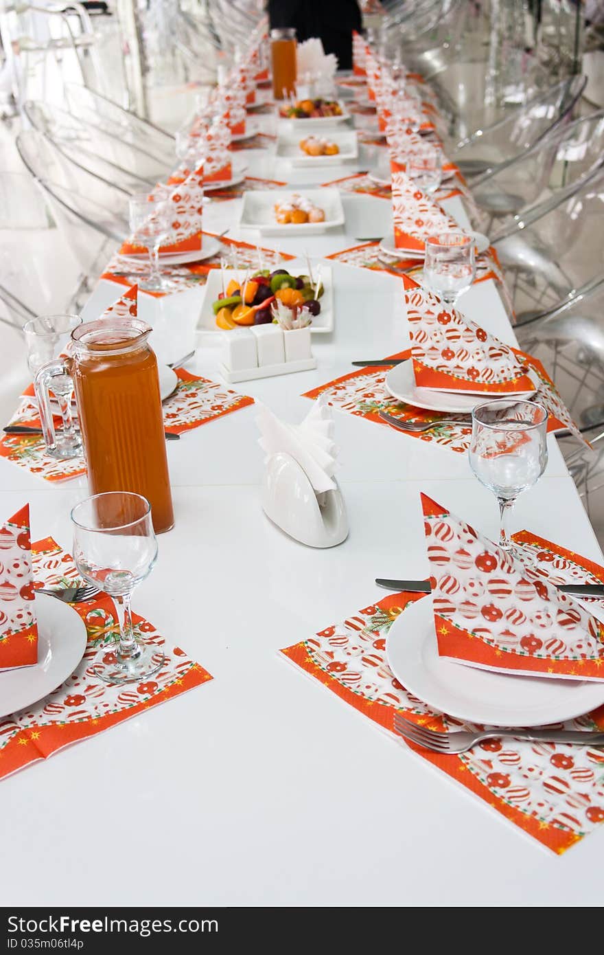 Catering table set with silverware, napkins and glasses at restaurant before party