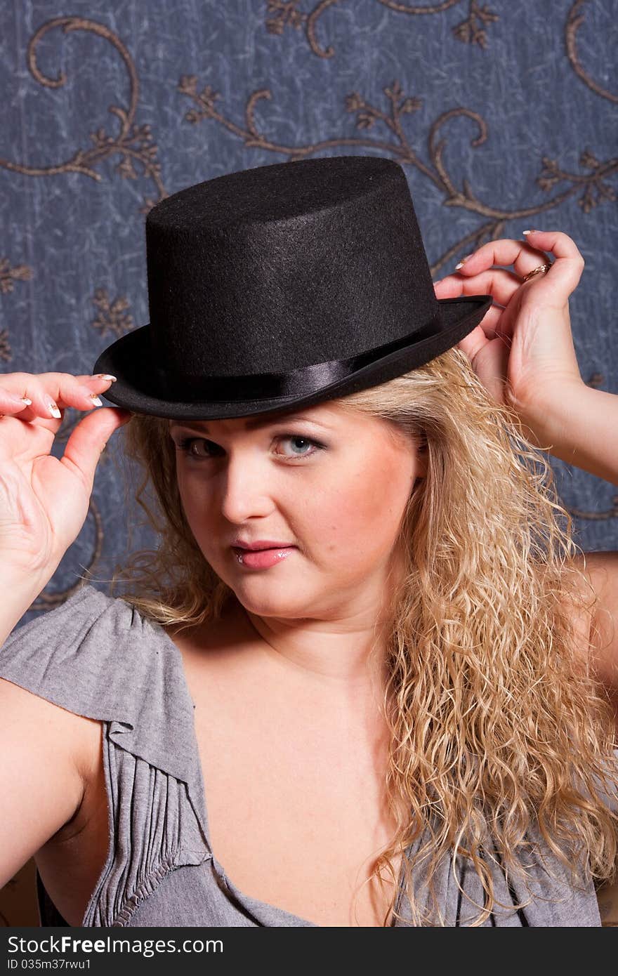 Charming young woman in a hat looking at camera. Charming young woman in a hat looking at camera