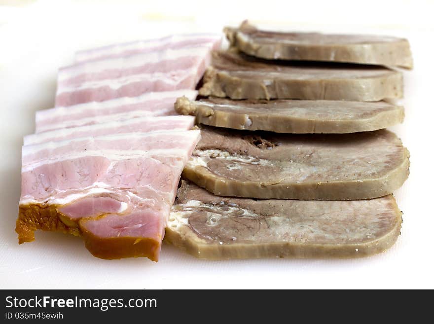 Meat cutting beef tongue and bacon isolated