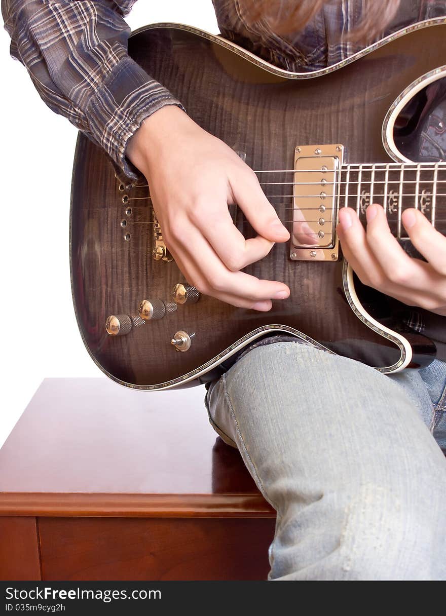 Guitarist playing against white background