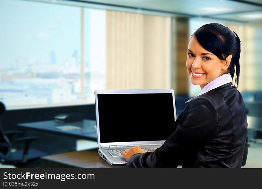 Young business woman on a laptop - isolated on white