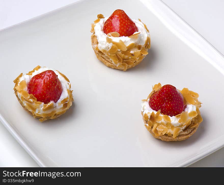 Strawberry tarts on a sqare plate, closeup