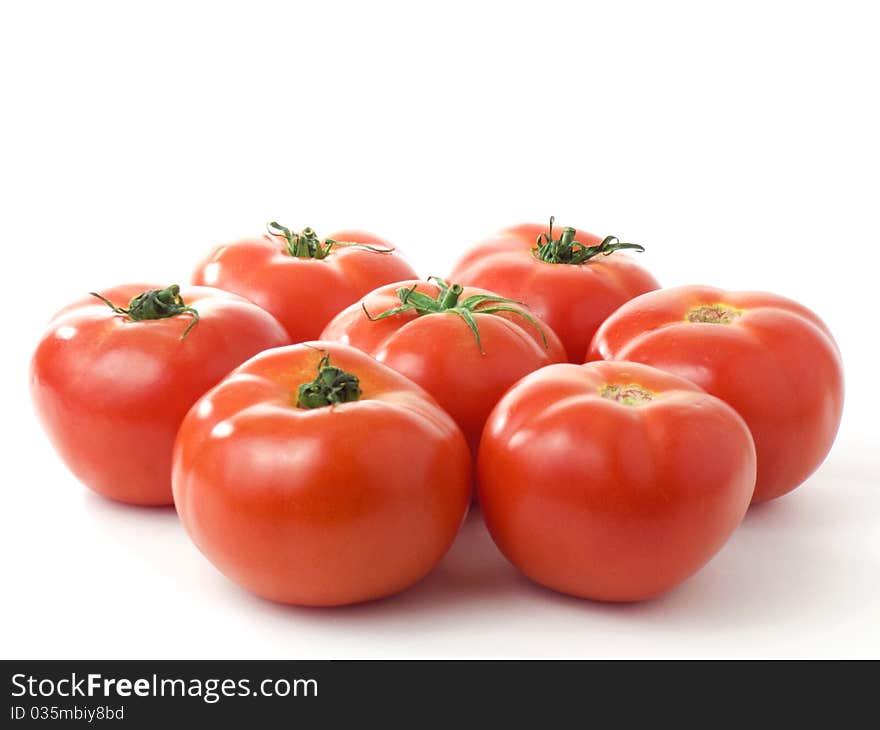 Seven fresh shiny tomatoes isolated