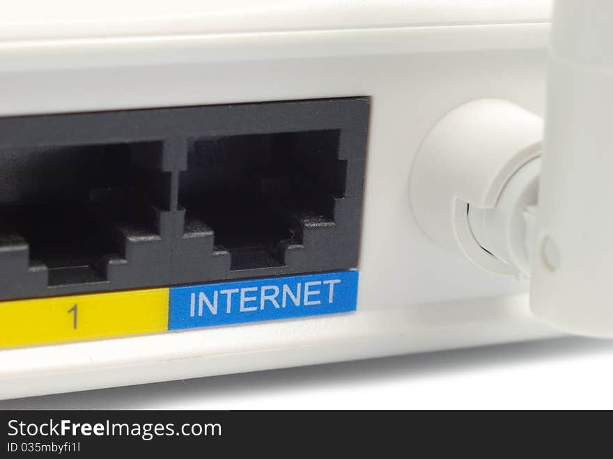 Fragment of wireless router. Back side with 2 LAN sockets and antenna. White background. Fragment of wireless router. Back side with 2 LAN sockets and antenna. White background.