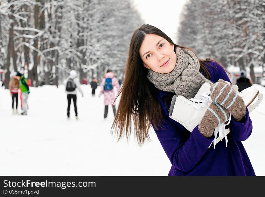 Attractive brunette young woman on the ice rink