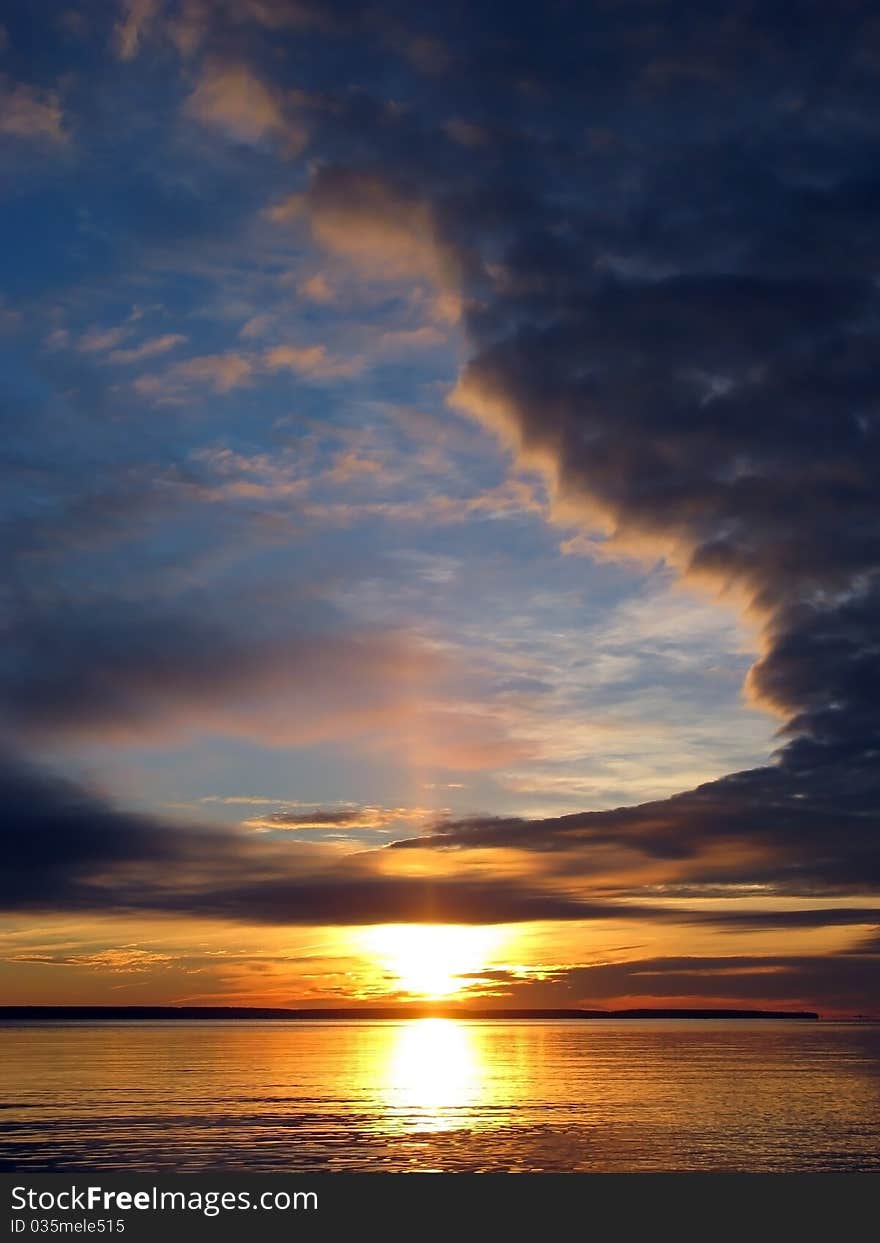 Sun is rising behind dark clouds. Sun is rising behind dark clouds