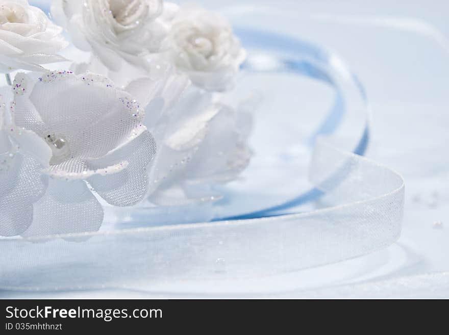 White flowers from a wedding on blue background with blue and white ribbon. White flowers from a wedding on blue background with blue and white ribbon