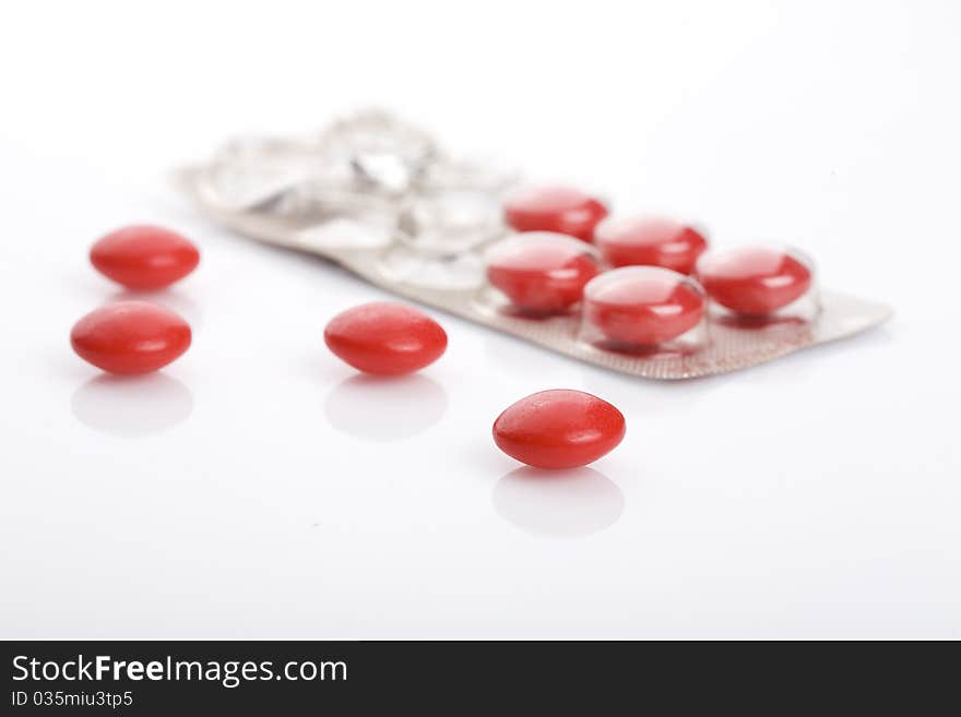 Red pills isolated on white background