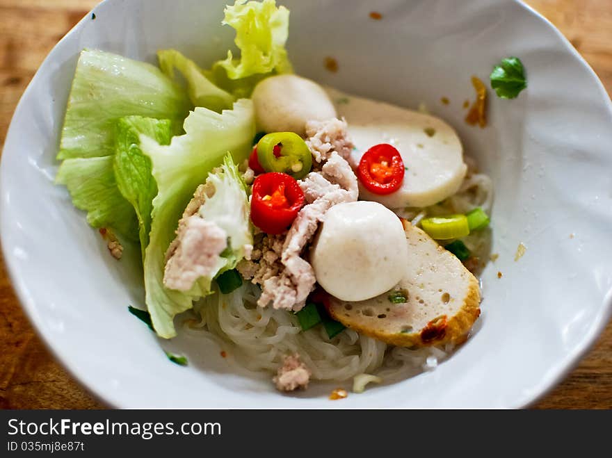 Asian style noodle with pork , fish ball and vegetables