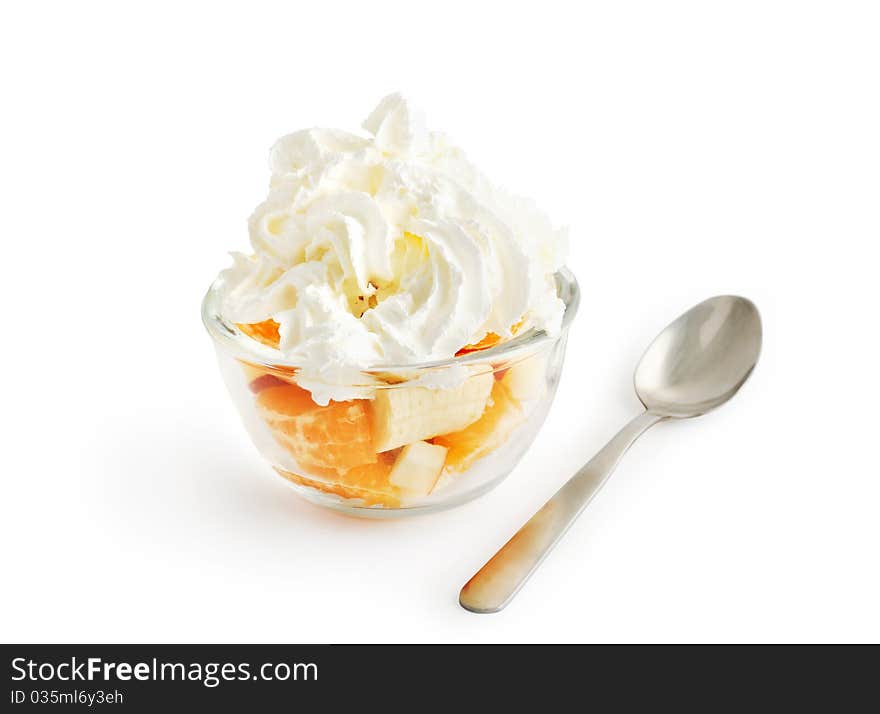 Fruit salad with whipped cream in a glass bowl isolated on white with clipping path. Fruit salad with whipped cream in a glass bowl isolated on white with clipping path