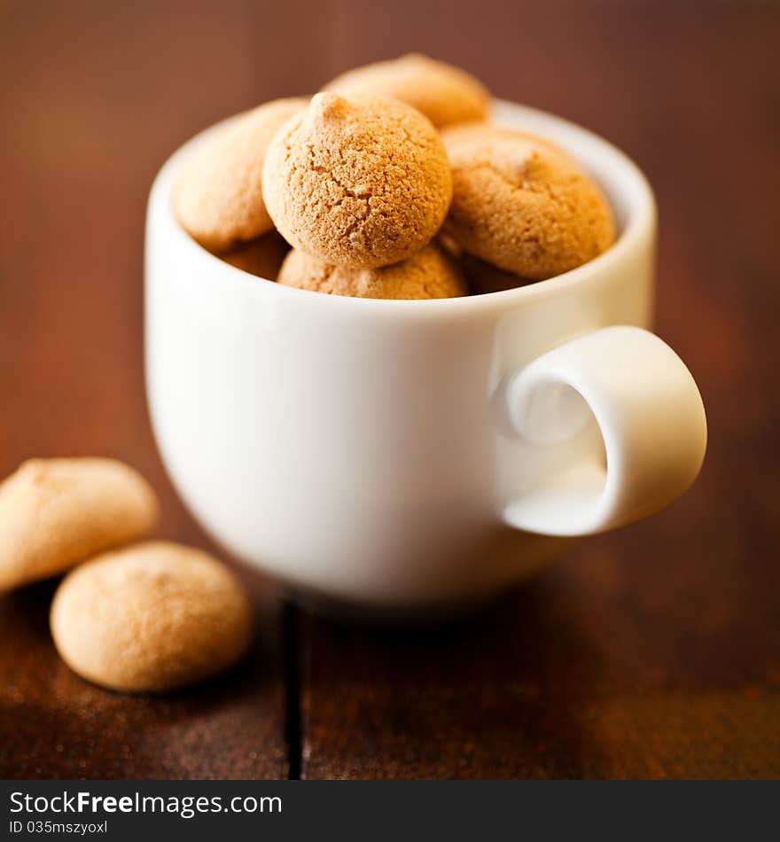 Closeup of a white coffee cup with biscotti