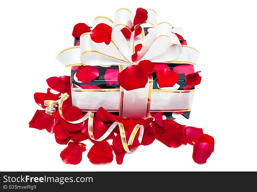 Gift decorated ribbon and rose petals isolated on white