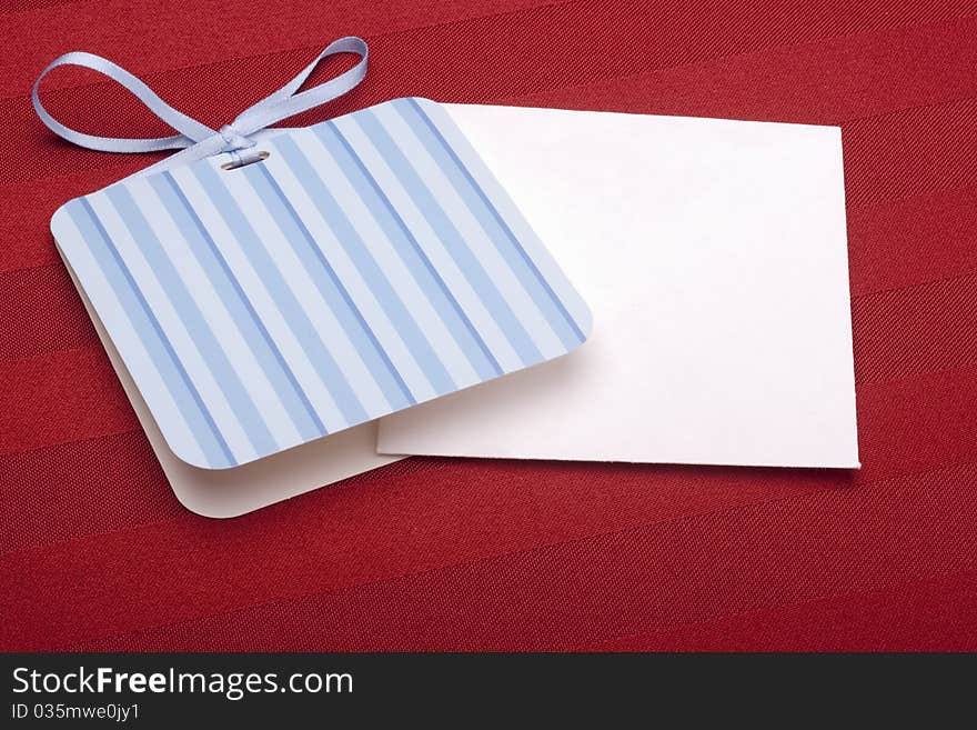 Greeting card with a blue ribbon on a red background.