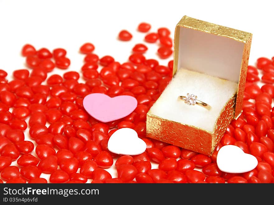 An engagement ring on some heart candy.