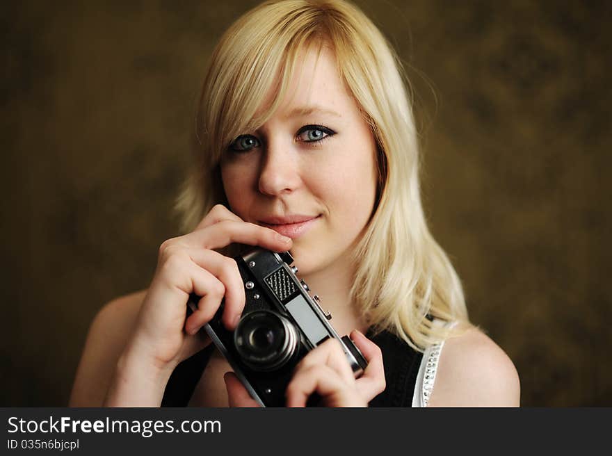 An image of a young woman with a camera. An image of a young woman with a camera