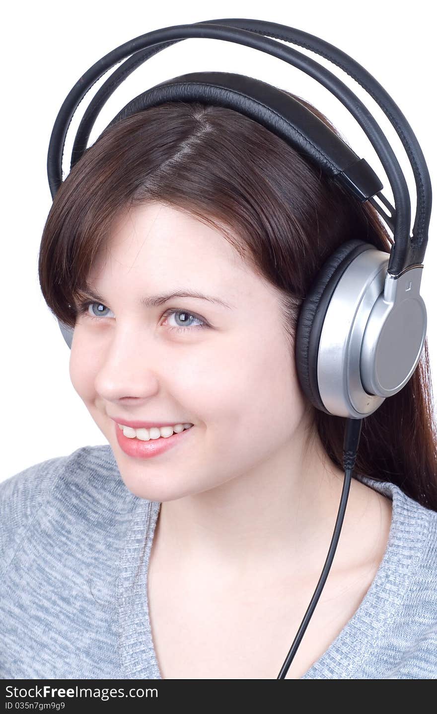 The girl in ear-phones on a white background