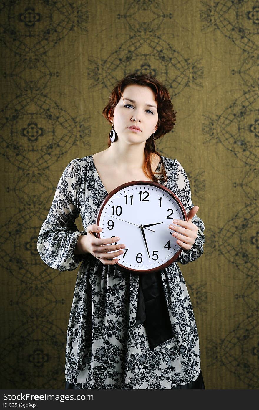 An image of a woman with a big clock. An image of a woman with a big clock