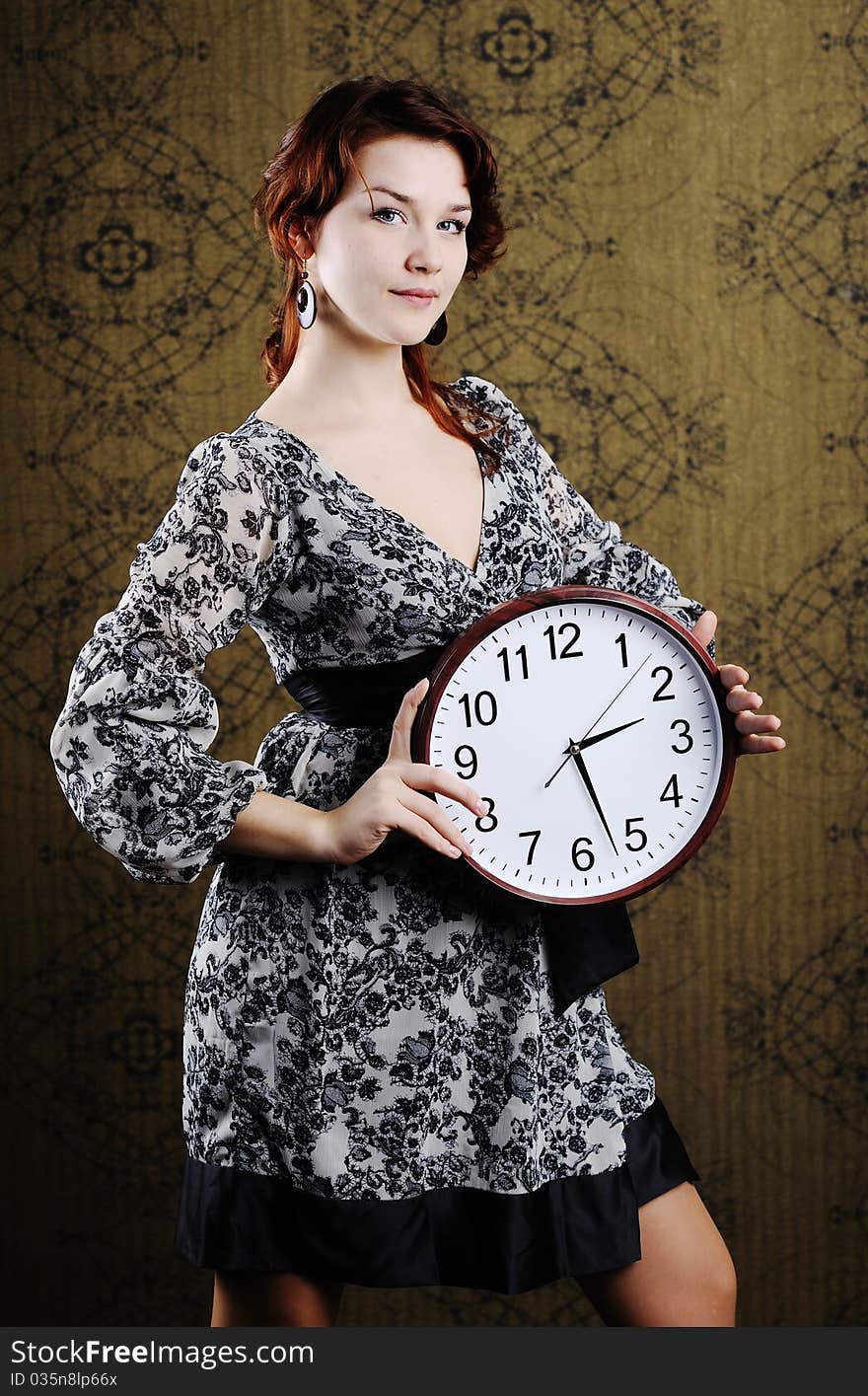 An image of a woman with a big clock. An image of a woman with a big clock