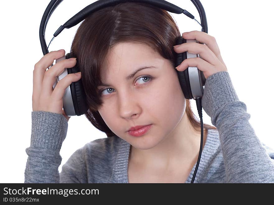 The girl in ear-phones on a white background